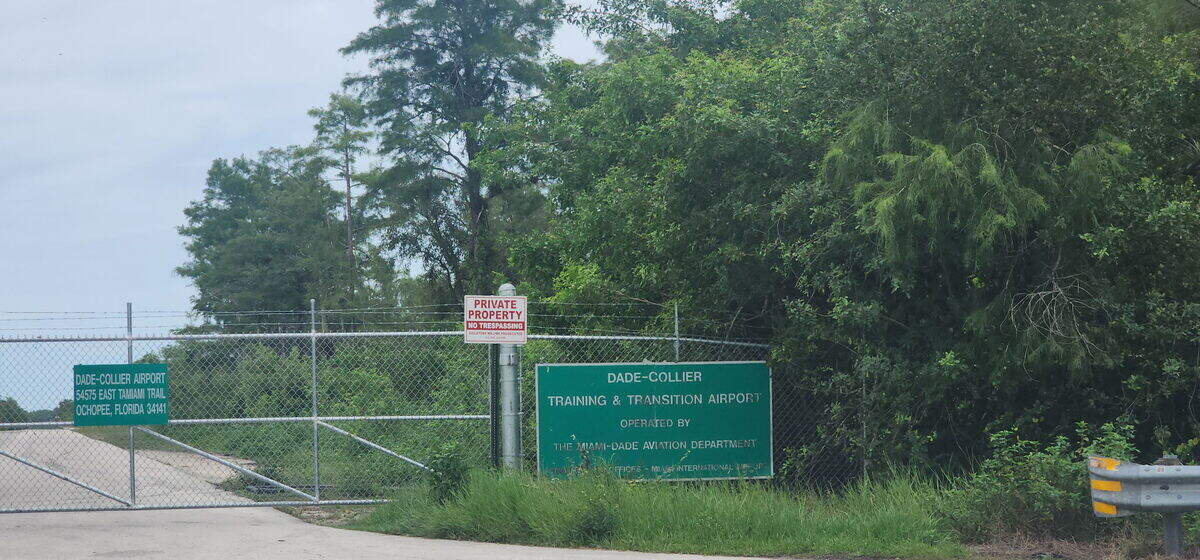The bright blue sign that read ‘Alligator Alcatraz’ has been taken down and replaced with the original Dade-Collier Training and Transitional Airport sign. The gate shut.